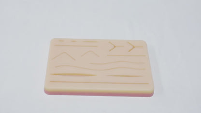 Almohadilla para práctica de sutura